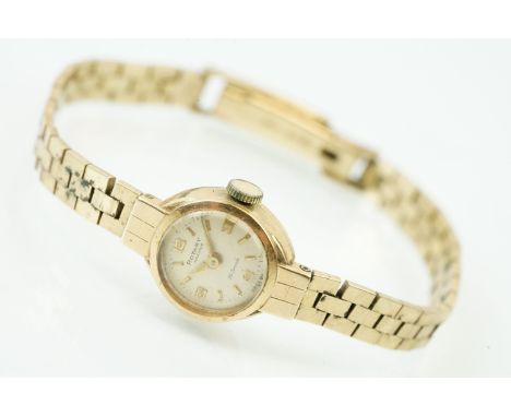 9ct gold ladies Rotary Maximus wrist watch having a round face with Arabic and baton numerals to the chapter ring set to a br