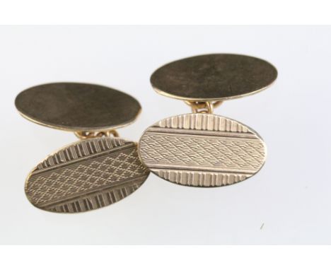 Pair of 9ct gold cufflinks having oval heads with engine turned details. Hallmarked Birmingham 1927. Heads measure 2cm. 
