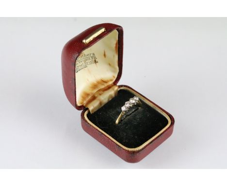 18ct gold and platinum four stone diamond ring. The ring being set with four round brilliant cut diamonds in cathedral settin