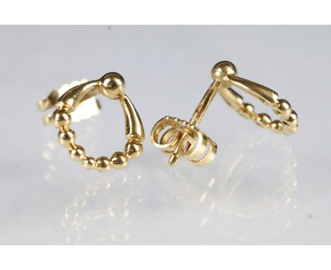 Pair of French 18ct gold door knocker stud earrings. Each with French eagle marks to posts. Measures 12mm. 