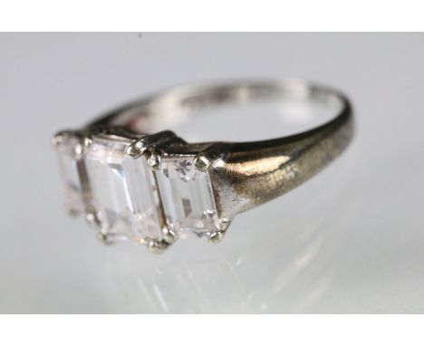9ct white gold and cubic zirconia three stone ring being set with three step cut CZ's. Hallmarked London 1992. Size N.5. 