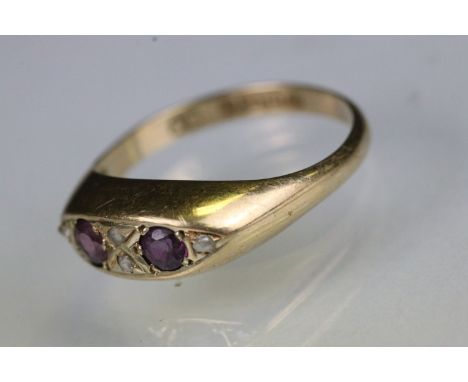 18ct gold ruby and diamond ring. The ring being set with two round cut rubies with diamond accent stones. Hallmarked Birmingh