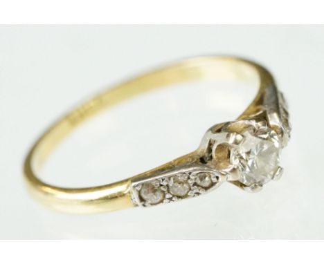 Early 20th Century 18ct gold and diamond ring. The ring being set with a round brilliant cut diamond to the head flanked by s