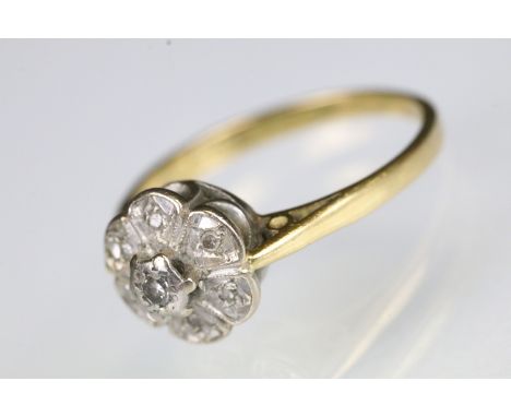 18ct gold and diamond cluster ring illusion set with round cut diamonds. Hallmarked Birmingham, date letter rubbed. Size M.5.