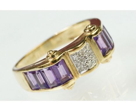 9ct gold amethyst and diamond ring. The ring having a panel of pave set diamonds to the centre flanked by four step cut ameth