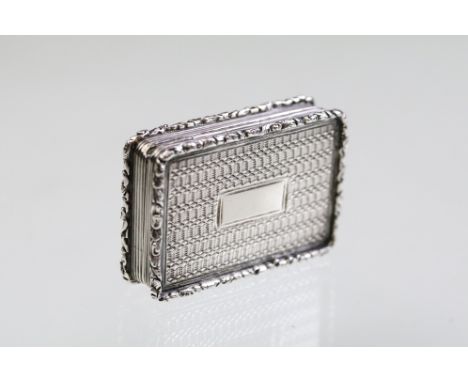 Early 19th Century William IV silver vinaigrette having an engine turned exterior with chased floral borders and vacant panel