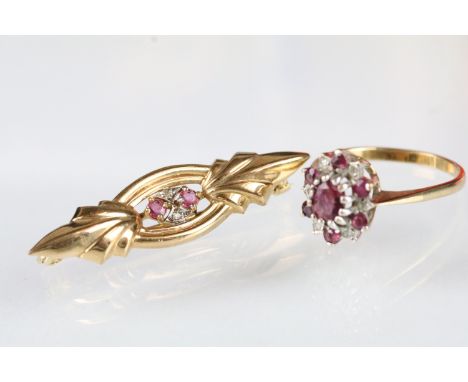9ct gold ruby and diamond cluster ring. The ring being set with an oval cut ruby surrounded by six round cut rubies and six r