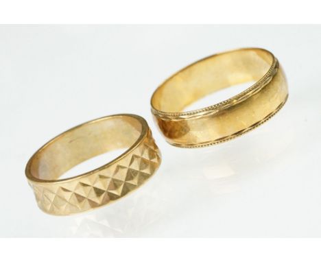 Two 9ct gold band rings to include a faceted band ring (size N), and a D shaped band with border (size R). Both hallmarked. 