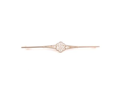 A diamond set bar brooch, a cluster of seven old cut diamonds 11.5mm diameter set to the centre of a yellow and white metal b