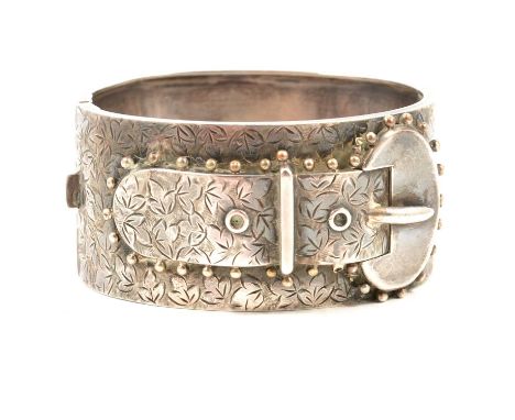 A Victorian silver half hinged bangle, buckle design on an ivy leaf background to front, Birmingham 1883, 30mm wide, internal
