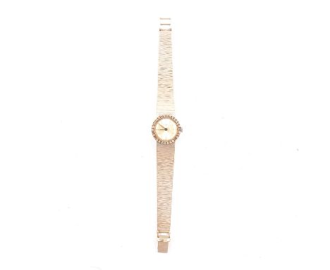 A French white metal and diamond lady's wristwatch, 16mm circular champagne baton dial in a 21mm circular white metal gold ca