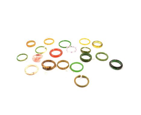 Nineteen Bakelite, Lucite and early plastic slave bangles, circa 1930's, mottled green and amber colours, one ivory coloured 
