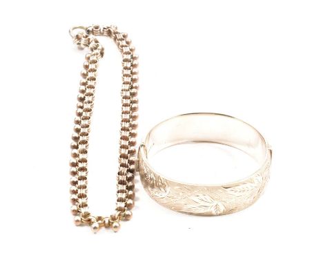 A silver half engraved Victorian style bangle, 18mm wide, decorated to front and back with a finely textured ground and polis