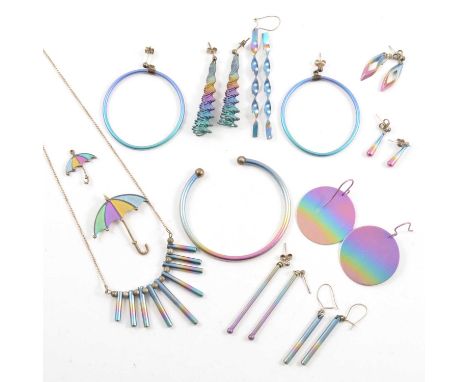 A collection of vintage colourful titanium jewellery with an iridescent finish, a 3mm open ended torque bangle, various earin