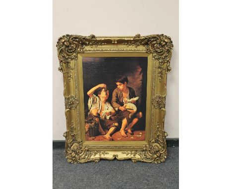 An ornately framed picture depicting two children, 82 cm x 101 cm  CONDITION REPORT: This is a textured print. 
