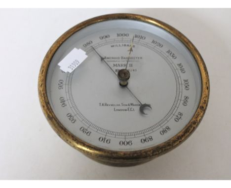 A circular brass cased aneroid barometer by T. A. Reynolds and Son of London 