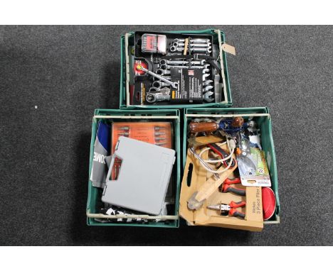 Three plastic crates containing assorted hand tools 