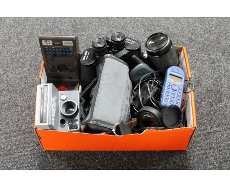 A box containing Zenith field glasses, cameras, vintage mobile phones, hand-held UFO Invaders game etc