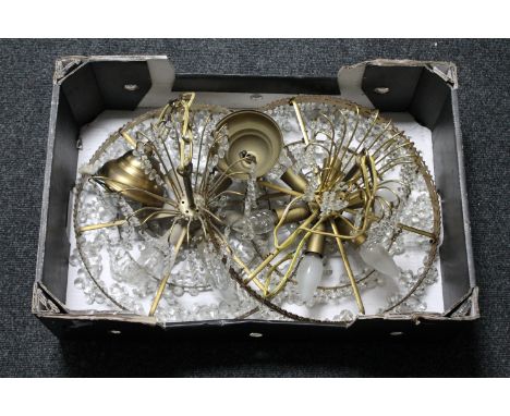 Two brass light fittings with glass drops 