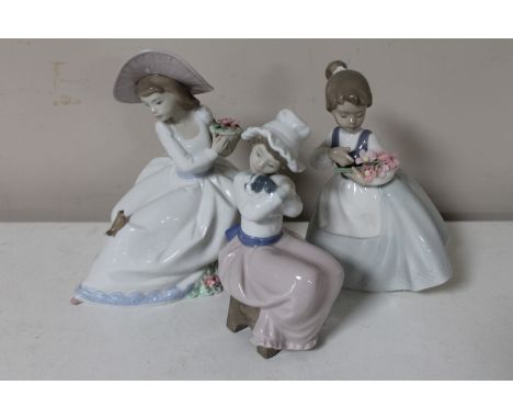 Three Nao figures; girl seated with flowers, girl with bunch of flowers and girl cuddling puppy