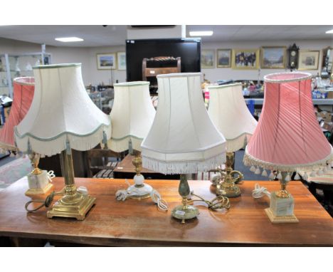 Three brass and onyx table lamps with shades together with a brass and marble table lamp with shade and two further brass tab