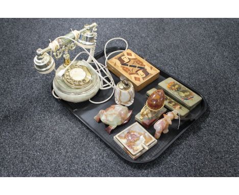 A tray of onyx pieces - telephone, table lighter, ash tray, animal ornaments and a treen card box, two George V commemorative