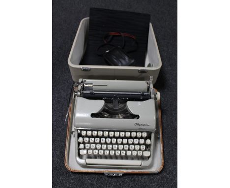 A cased Olympia typewriter and a Halina camera