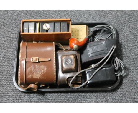 A tray containing leather cased binoculars, vintage camera, pipe, ivory fronted dominoes, enamelled badge, cribbage board 