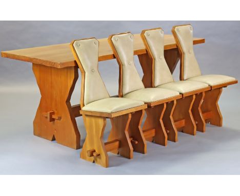 An English Arts &amp; Crafts style pine dining suite, each piece carved with joiner’s signature of a carpenter figure, compri