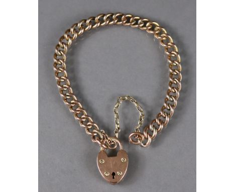 A 9ct gold curb-link bracelet with padlock clasp &amp; safety chain (8.7g).