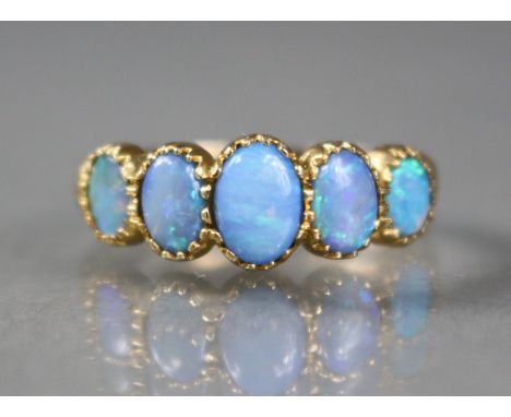 A 9ct gold ring set five graduated oval-cut opals, size Q, 3g.