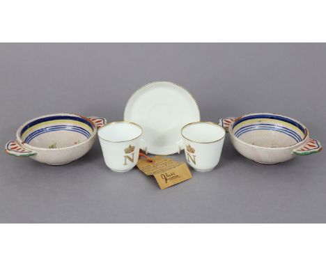 A pair of Quimper ware circular two-handled bowls with painted decoration, 7” wide; &amp; a pair of French porcelain teacups 