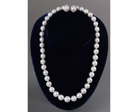 A single-row necklace of large graduated freshwater pearls between 14mm to 9mm dia., with platinum mounts; a pair of similar 