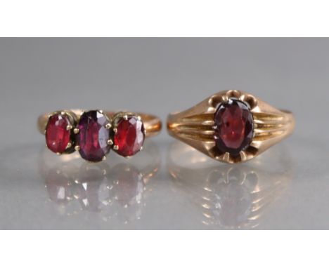 A 9ct. gold ring set three graduated oval garnets, size: O/P; 2.4gm; &amp; another set single garnet, size: S; 3gm. 