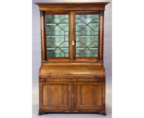 An early/mid-19th century rosewood bureau bookcase fitted three shelves enclosed by a pair of astragal glazed doors with turn