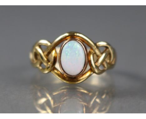 A 9ct gold Clogau Mine ring set oval-cut opal, with pierced Celtic knot shoulders; size K, 2g.
