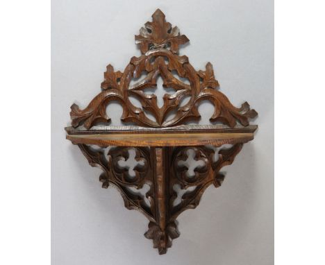 A late 19th/early 20th century carved &amp; pierced oak folding wall bracket in the Gothic-revival style, 39cm high x 30cm wi