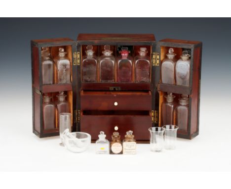 English, c.1850, French polished mahogany case with double opening doors, with 12 glass bottles in compartments, with 2 fitte