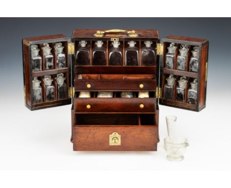 An Early 19th Century Domestic Medicine Chest, English, c.1820, constructed of French polished mahogany with large brass hand