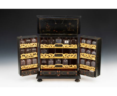 A Regency Chinese Medicine Chest, Chinese, c.1800, the fine Regency double fronted chest painted in the Chinese style on a bl