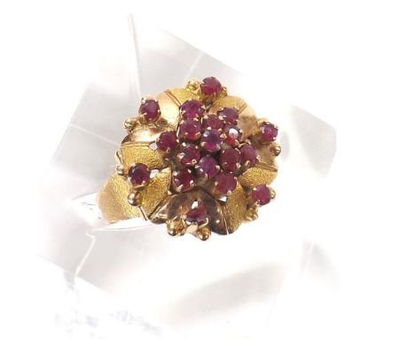 Yellow metal ruby set floral ring, 7.4gm, 18mm diameter, ring size P
