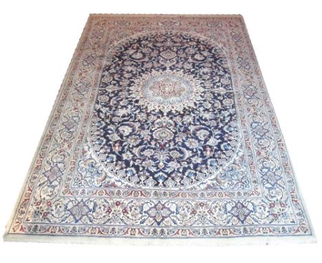 FINE PERSIAN NAIN CARPET, 348cm x 232cm, organic medallion on a midnight blue field of scrolling vines and palmettes within c