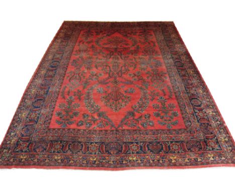 ANTIQUE KASHAN CARPET, 420cm x 310cm, maroon field with floral bouquets and shrubs within matching floral borders. 