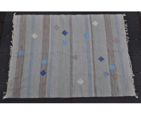 A 20th century Turkish kilim rug carpet. The rug having a series of horizontals with goz throughout in various shades of blue