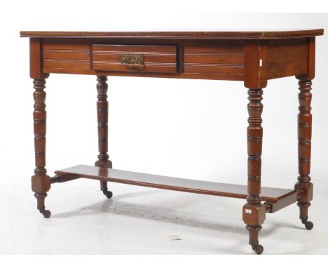 An early 20th century Edwardian mahogany console table writing desk. The desk featuring carved tramline decoration to front, 