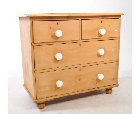 A 19th century Victorian pine wood chest of drawers. The chest of drawers raised on bun feet. Having a two short over two lon