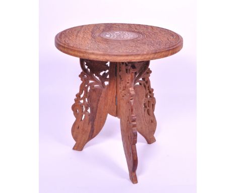 Late 20th century Indian oak carved folding stool / small table. Featuring a circular table top with carved flowers and white