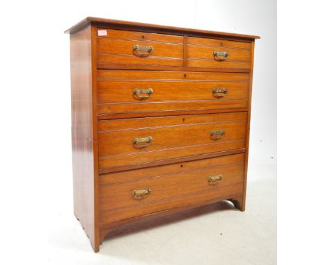 An early 20th century Edwardian mahogany chest of drawers. The chest of drawers raised on bracket feet, having a two short ov