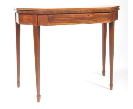 A 19th century George III mahogany games card table. The table having crossbanded top with canted edge, opening to reveal a b