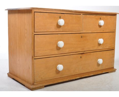 A 19th century Victorian pine low chest of drawers. The chest of drawers raised on small turned bun feet. Having a two short 